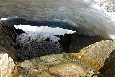 snow bridge: an arc formed by snow across a crevasse or creek, etc