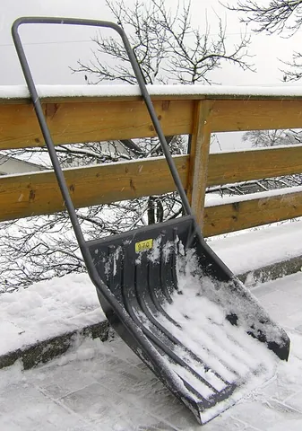 snow scoop: a manual snow removal tool with a large scoop and wide handle, used to move snow by pushing and...