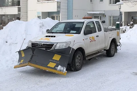 snowplow: a motorized vehicle that is used to push snow off flat surfaces such as roads and parking lots