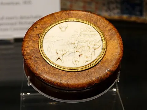 snuffbox: a small box or container to hold snuff or loose tobacco