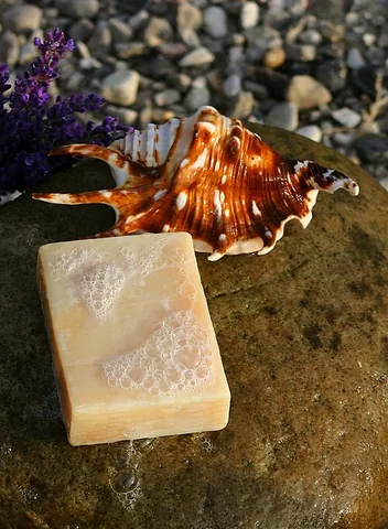 soap bar: a bar of soap, comfortably sized to fit in the palm of one's hand