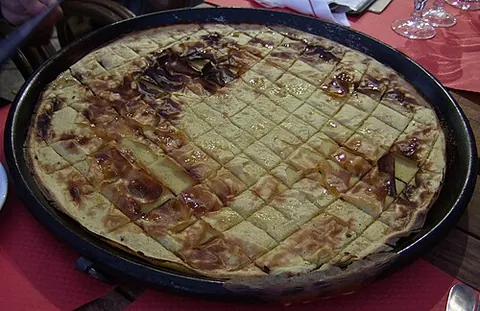 socca: a French dish popular in Nice; a kind of chickpea pancake seasoned and eaten hot