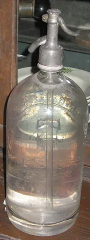 soda siphon: a stout glass bottle containing soda water under pressure, at one time found in bars. A...