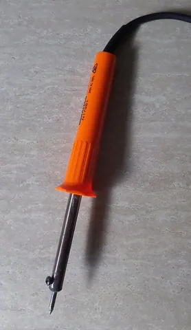 soldering iron: a hand-held tool with a heated tip, used to melt and apply solder