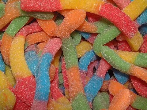 sour worm: a sweet-and-sour confectionery made of gelatin and often, but not always, in the shape of a toy worm