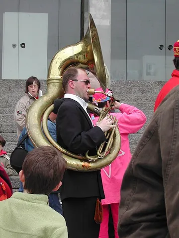 sousaphone: a valved brass instrument with the same length as a tuba, but shaped differently so that the bell...