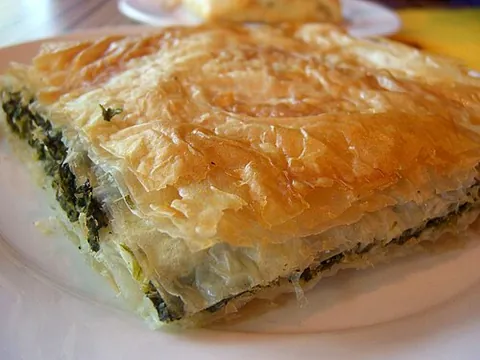 spanakopita: a Greek dish made with pre-cooked spinach, butter, olive oil, cheese, green onions, egg, and...