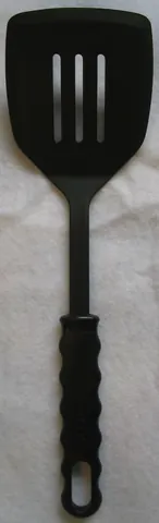 spatula: a kitchen utensil consisting of a flat surface attached to a long handle, used for turning,...