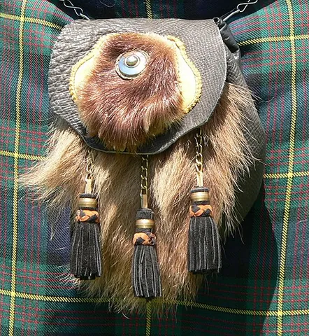 sporran: a small pouch, usually made of either fur or plain or fur-trimmed leather, which is worn, suspended...
