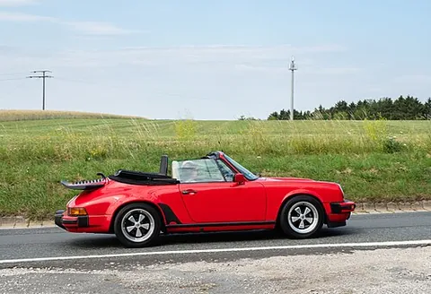sports car: an automobile designed for high speed and power, tight handling, and flashy looks