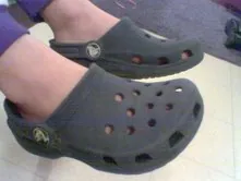 sports mode: wearing crocs and flipping the heel strap from the frontward position to the back, securing it...