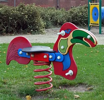 spring rider: a children's playground item consisting of a large spring beneath a central beam or flange on which...