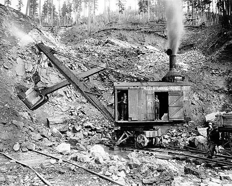 steam shovel: an excavating machine designed to effect a shovelling action through steam power