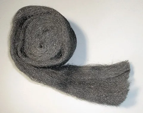 steel wool: fine strips or threads of steel, usually formed into pads or balls and used as an abrasive