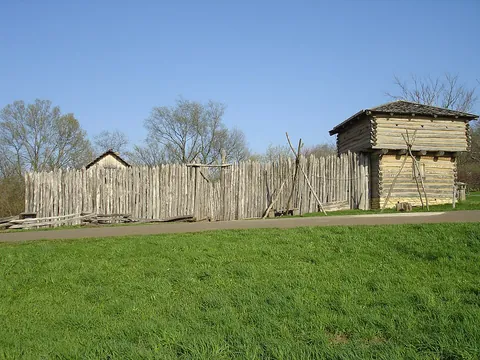 stockade: an enclosure protected by a wall of wooden posts