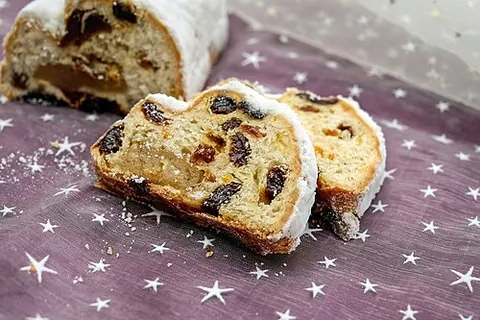 stollen: a traditional German cake eaten at Christmas time, made with nuts, raisins and other dried fruits