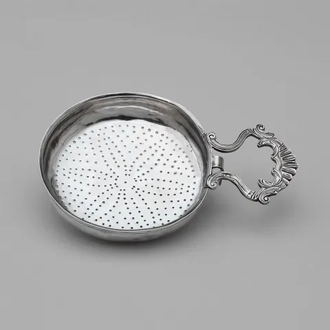 strainer: a device through which a liquid is passed for purification, filtering or separation from solid...