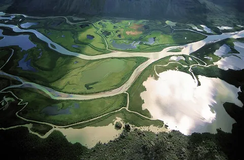 stream: a small river; a large creek; a body of moving water confined by banks