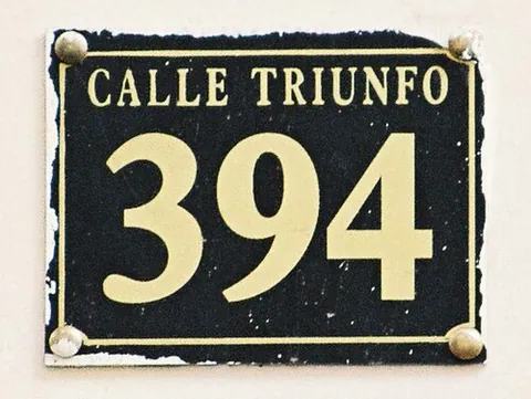 street address: the address of a building, typically comprising a house number, street name, city, and postcode