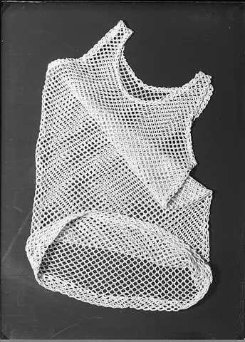 string vest: an undergarment made from a see-through mesh fabric, usually worn by men
