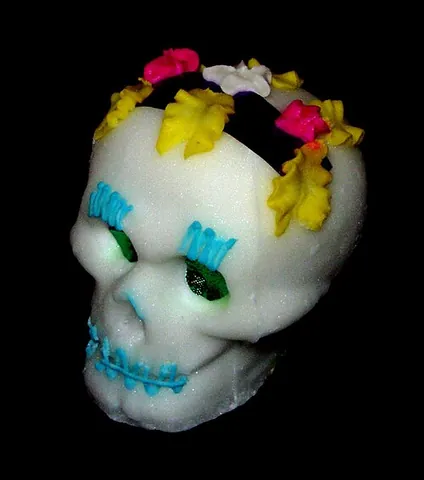 sugar skull: a brightly colored skull face icon, placed on the grave of the deceased to celebrate their life...