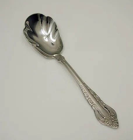 sugar spoon: a spoon used for serving granulated sugar from a sugar bowl, often with a wider head than most...