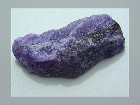 sugilite: a mineral with hexagonal crystals, often pink or purple but can have different colors,...