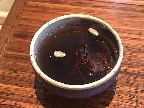 sujeonggwa: a sweet beverage made from ginger and cinnamon powder, sometimes served with dried persimmon and...
