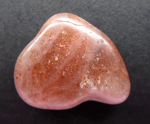 sunstone: a translucent form of feldspar having flakes of hematite, used as an ornamental stone
