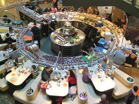 sushi train: a conveyor belt system designed to circulate freshly prepared sushi throughout a restaurant,...