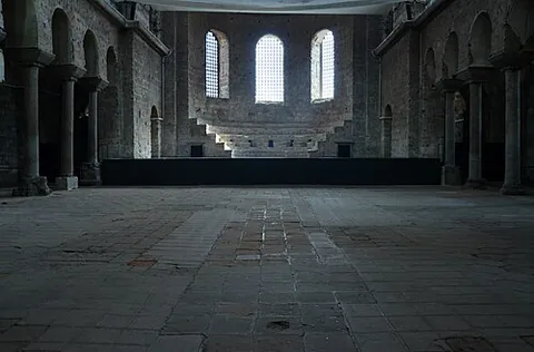 synthronon: a structure, in the apse, containing the cathedra and seating for priests assisting a bishop
