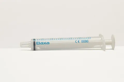 syringe: a device used for injecting or drawing fluids through a membrane