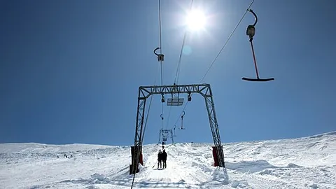 t-bar: a type of ski lift where skiers/snowboarders are dragged up the ski run while they slide along on...