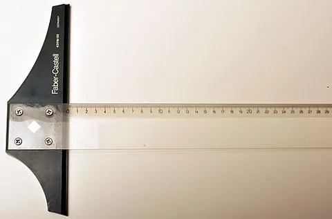 t-square: a rule with a short perpendicular crosspiece at one end, used by draughtsmen to draw parallel lines