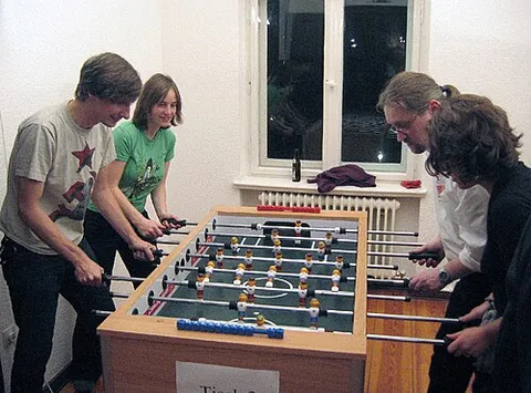 table football: a game, based on football (soccer), in which opposing players are represented by small figures...