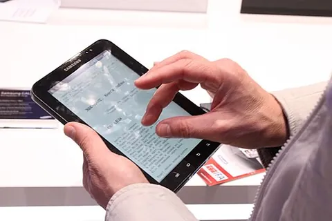tablet computer: a hand-held portable computer in the form of a tablet with a touch screen interface