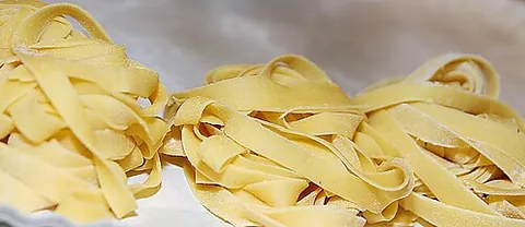tagliatelle: long, flat ribbons of egg pasta, originally from Emilia-Romagna, sliced from a rolled-out sheet