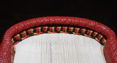 tailband: an endband attached to the bottom of the spine of a book