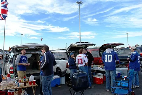 tailgate party: a celebration, held in a parking lot, with picnic food served out of the back of automobiles or...