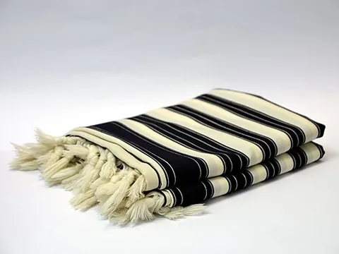 tallit: a traditional Jewish prayer shawl with tassels which covers the chest and upper part of the back