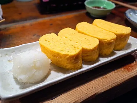 tamagoyaki: a Japanese omelette made by rolling together several layers of cooked egg, usually prepared in a...