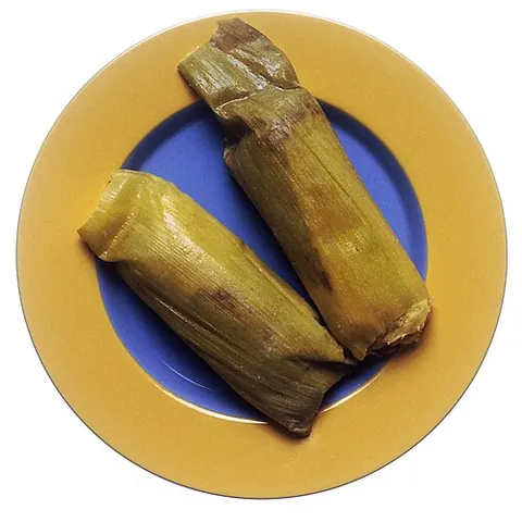 tamale: a Mexican dish of cornmeal dough shell filled with various ingredients (e.g. chopped beef, pork,...