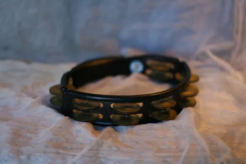 tambourine: a percussion instrument consisting of a small, usually wooden, hoop closed on one side with a drum...