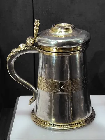 tankard: a large drinking vessel, sometimes of pewter, sometimes with a glass base, with one handle and...