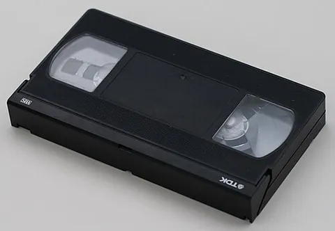 tape: flexible material in a roll with a sticky surface on one or both sides; adhesive tape