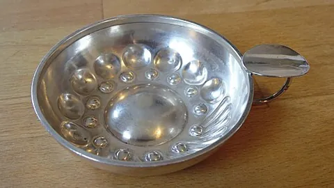 tastevin: a small, shallow cup or saucer with a reflective surface, traditionally used by winemakers and...