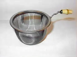 tea strainer: a strainer used to filter loose tea leaves from brewed tea