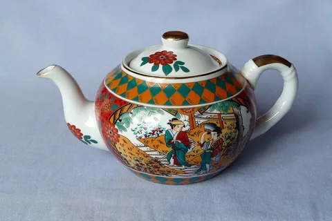 teapot: a vessel for brewing and serving tea, typically with a handle and spout
