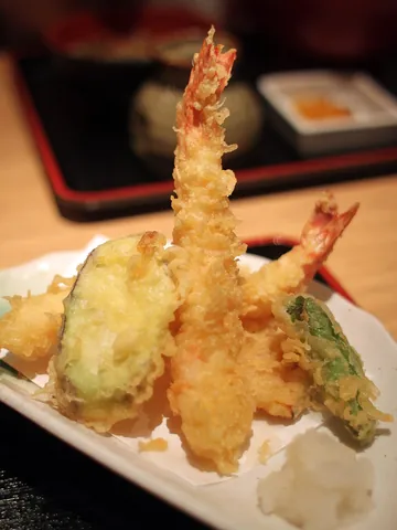 tempura: a Japanese dish made by deep-frying vegetables, seafood, or other foods in a light batter