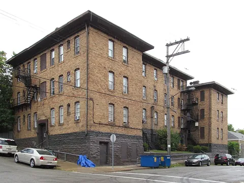 tenement: a building that is rented to multiple tenants, especially a low-rent, run-down one